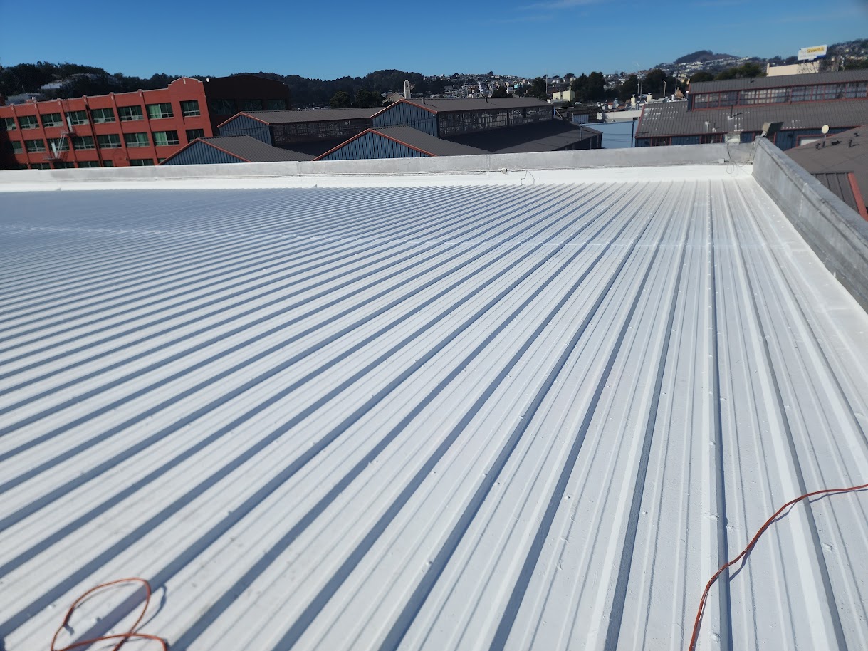 Freshly coated white metal roof on an SF commercial building