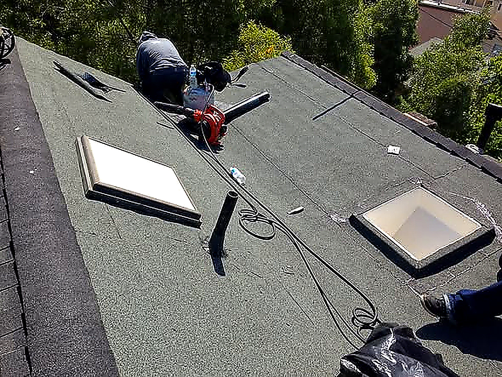 Crew installing skylights on a low-slope SF roof
